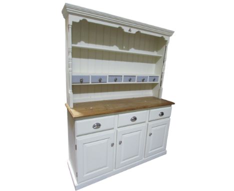 A modern pine kitchen dresser the base with three doors and three drawers, the plate rack with two shelves and six small draw
