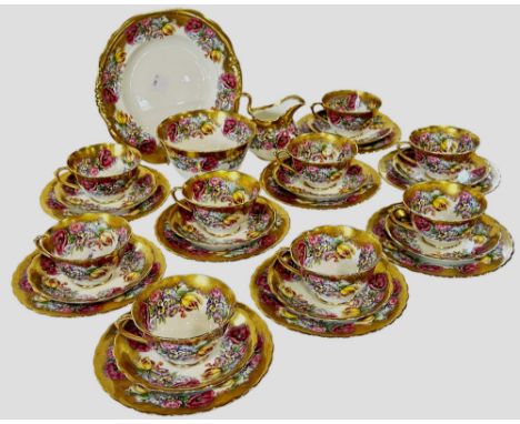 A highly decorative tea service with heavy gilt borders and floral bouquet detail comprising teacups, saucers and tea plates,