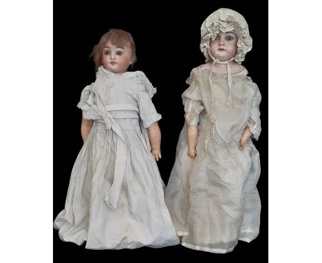 Two late 19th /early 20th century bisque shoulder head dolls comprising a child doll with blue closing eyes and cloth body by