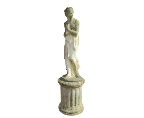 A large weathered garden cast composition stone figure in the form of a classically presented female nude, clutching drapery,