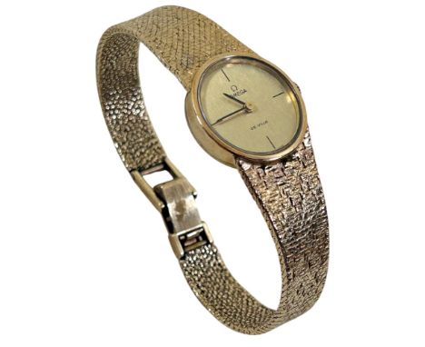 Omega; A ladies vintage 9ct yellow gold De Ville wristwatch on 9ct textured strap, 18mm case, 29g (gross weight)
