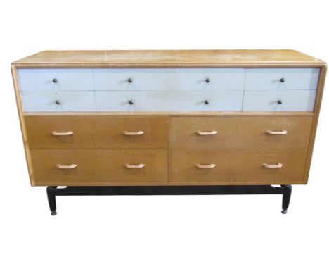 An E Gomme early G Plan oak dresser fitted with an arrangement of ten drawers on ebonised supports, 88 cm high x 151 cm x 46 