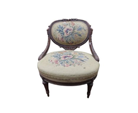 A 19th century French drawing room chair with carved show wood frame and needlepoint seat and back 