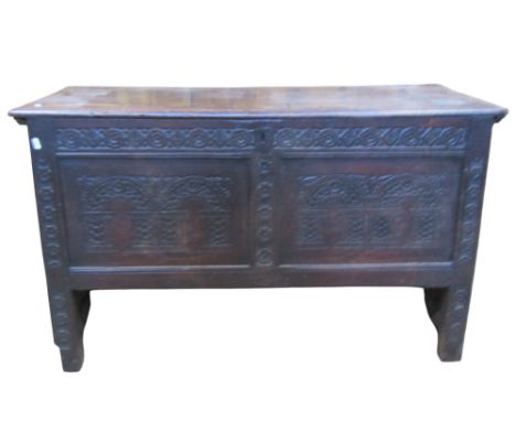 An 18th century oak coffer with panelled frame, hinged lid and carved front elevation, 70 cm high x 118 cm x 51 cm