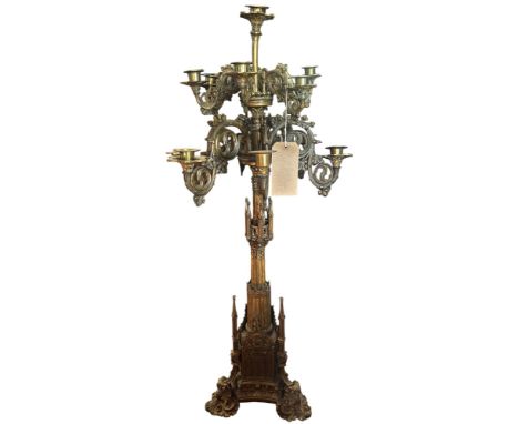 A tall and impressive Puginesque 19th century continental gothic thirteen light floor-standing candelabra, with scrolling arm