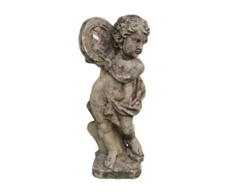 A weathered composition stone garden figure in the form of a classical putto, the figure in drapery, holding aloft a tambouri