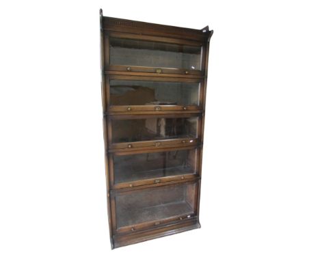 A five tier oak modular stacking bookcase.  The Lebus with glazed up and over doors, 190 cm high x 88 cm wide x 32 cm deep