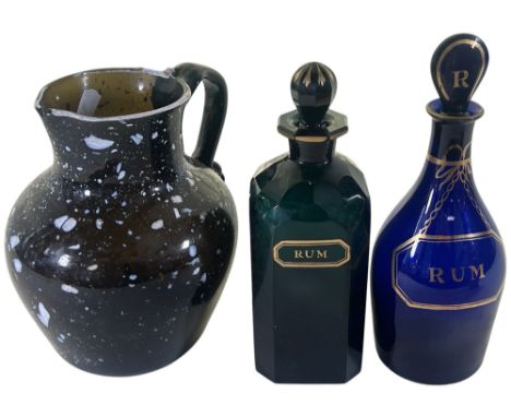 A Bristol Blue Glass Rum decanter 23cm high, another green glass rum bottle 22cm high and a 19th century Nailsea speckled gla