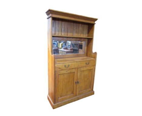 A small early 20th century oak dresser with enclosed back, centred with bevelled mirror plate over two drawers and cupboard d