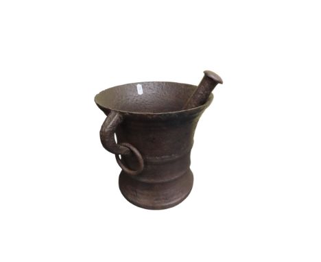 An early iron pestle and mortar with loop and ring handles, 22cm high x 22cm diameter