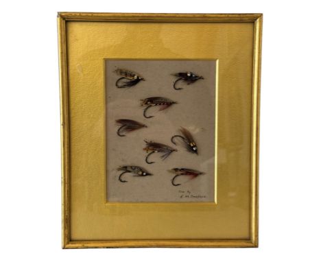 A framed set of eight fly fishing hooks inscribed 'Tied by E.M. Crosfield' (Ernest Crosfield, renowned British salmon fly dre