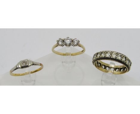 Three gold rings; an 18ct platinum set melee diamond solitaire ring, size R/S, 2g, a 9ct three stone dress ring, 2.5g size R/