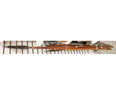 Three African spears, a pair of paddles and a reeded wooden flute cared&nbsp;with reeded ornament, all wooden handled&nbsp;