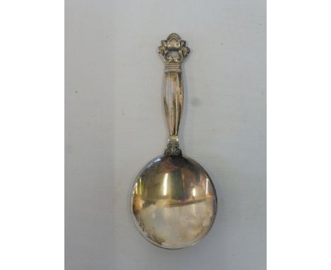 Georg Jensen: a caddy spoon with a foliate and scrolled finial. 
