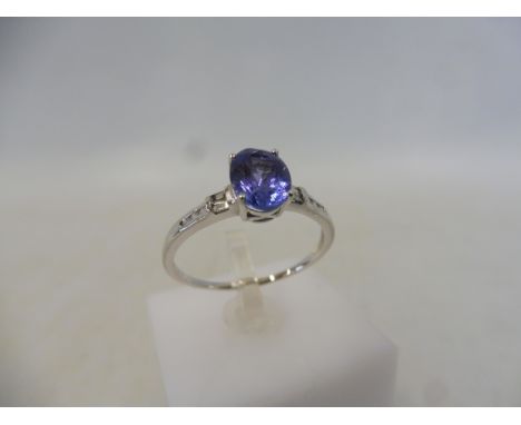 A tanzanite and diamond white gold ring, size S to T, approx. weight 2.2g.