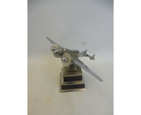 A good quality Art Deco chrome plated and hardwood model of a twin propeller aeroplane on a stepped base.