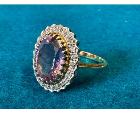 A 9ct gold amethyst and diamond ring, approx. 4.6g, hallmarked London and 'Dia .12', size R. 