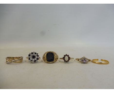 Four 9ct gold rings, approx. 10.4g, a higher grade of gold wedding band, cut, approx. 1.9g and another ring, probably gold, a