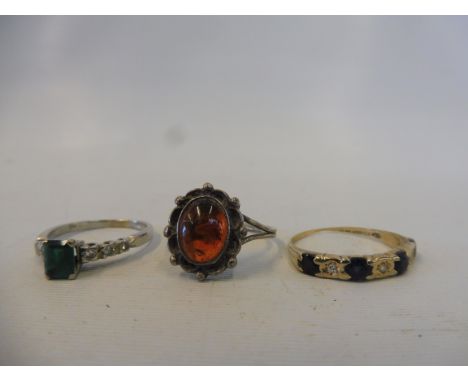 A gold sapphire and diamond ring, an emerald and diamond ring and a third set with amber, approx. 6.1g.