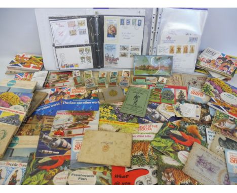 A quantity of tea cards in albums and two albums of first day covers.