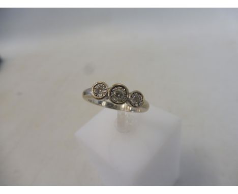 A cased 18ct white gold three stone diamond ring, size N/O, approx. 4.9g.