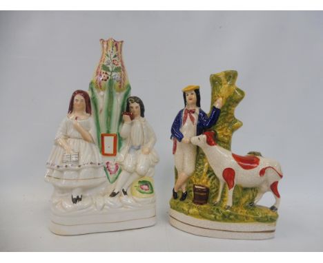 Two Staffordshire figural spill vases. 