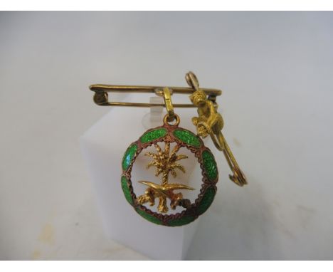 An unusual green enamel and yellow metal pendant, mounting loop indistinctly hallmarked, appears to be .750, approx. 5.3g and