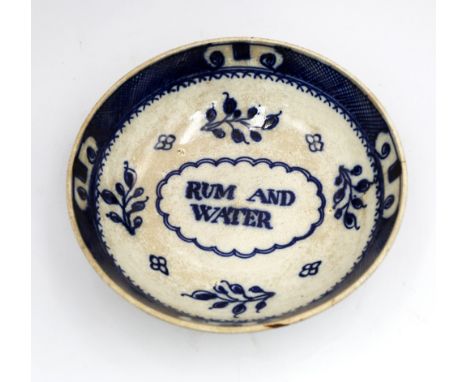 A 19th century Rum and Water ‘grog’ bowl, underglaze blue decoration, the central cartouche with Rum and Water written within