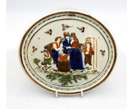 A late 18th / early 19th century Prattware relief plaque depicting figures and a horse amongst foliage, with brown border, of