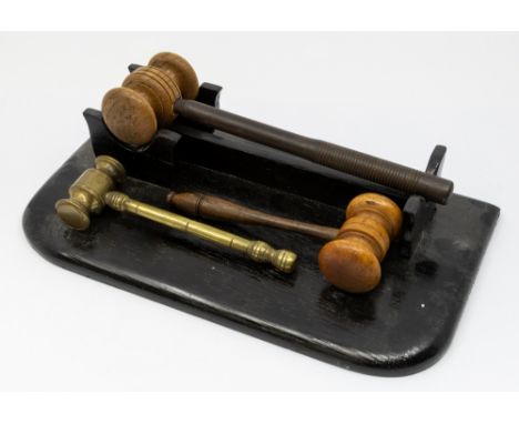 An early 20th Century gilt metal gavel together with two vintage turned wooden gavels and a painted wooden gavel stand (4)