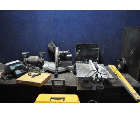 A COLLECTION OF POWER TOOLS including a Wickes compound mitre saw, a Black and Decker circular saw, a Wickes tile saw, a Perf