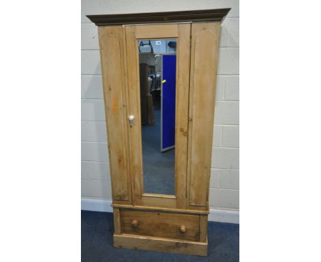 A 19TH CENTURY PINE WARDROBE, with a single mirror door, over a deep drawer, width 92cm x depth 49cm x height 194cm, conditio