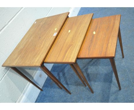 A MID-CENTURY TEAK NEST OF THREE TABLES, raised on cylindrical tapered legs, width 56cm x depth 38cm x height 47cm, condition