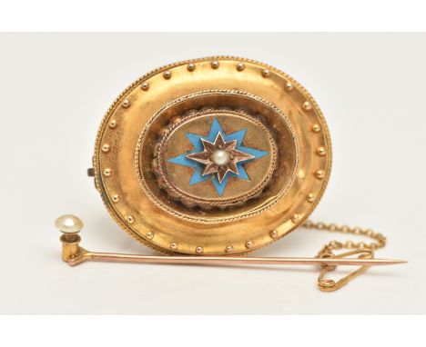A VICTORIAN BROOCH, an oval yellow metal brooch with a centrally set split pearl and blue enamel detail, rope and beading det