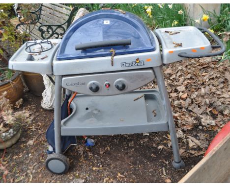 A CHAR-BROIL GARDEN CHEF BARBECUE, with under shelf, side burner and domed lid, width 128cm