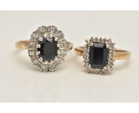 TWO SAPPHIRE AND DIAMOND CLUSTER RINGS, the first an emerald cut blue sapphire set with a surround of single cut diamonds, ye