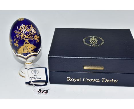 A LIMITED EDITION ROYAL CROWN DERBY 'PARADISE EGG' numbered 1037/3500, with gilt foliate patterns on a cobalt ground, raised 