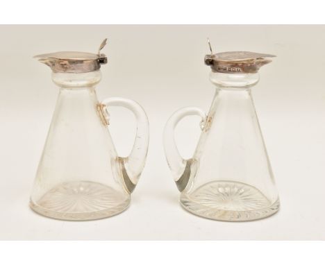 TWO SILVER MOUNTED GLASS WHISKEY TOTS, tapering glass forms fitted with handles, and a silver hinged cover, hallmarked 'Aspre