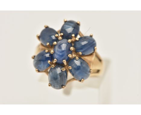 A MODERN 9CT GOLD GEM SET RING, seven oval cabochons, prong set into a floral design cluster, approximate width of mount 19mm
