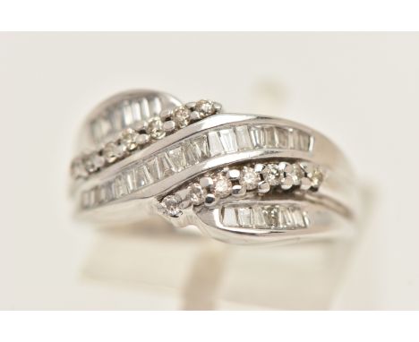 A MODERN 9CT GOLD DIAMOND RING, a cross over design ring set with baguette cut diamonds, tapered baguette cut diamonds and ro