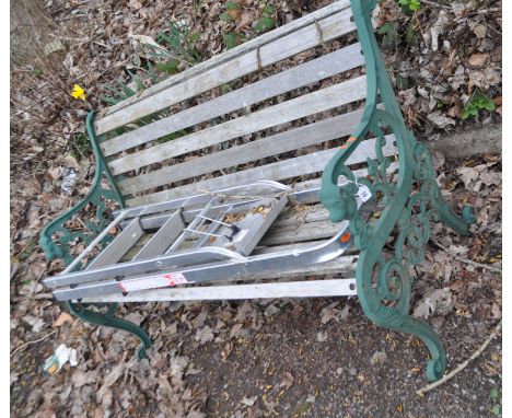 A LATE 20th CENTURY GARDEN BENCH, with cast iron ends, lion mask motifs, wooden slatted seat and back, width 128cm along with