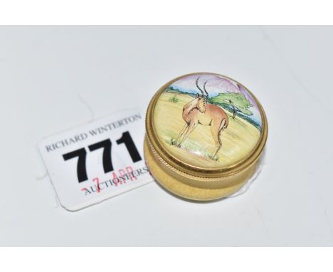 A MOORCROFT ENAMEL PILL BOX, decorated with an antelope in a naturalistic setting on the lid and a yellow base with twist off