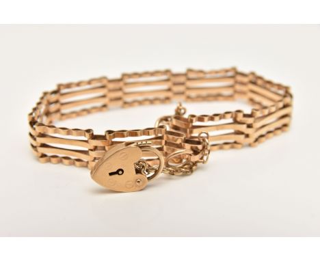 A 9CT GOLD GATE BRACELET, a yellow gold four bar gate bracelet, fitted with a heart padlock clasp, hallmarked 9ct London, app