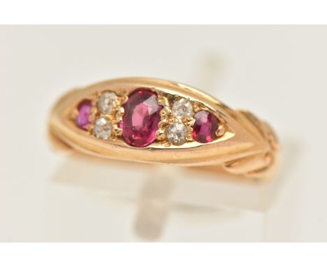 AN EARLY 20TH CENTURY GEM SET RING, a yellow metal boat ring set with three oval cut rubies and four old cut diamonds, hallma
