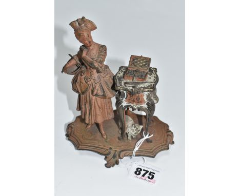 A CAST METAL FIGURATIVE INKWELL with a female figure beside a jewellery box with a cat below the table, in a continental styl