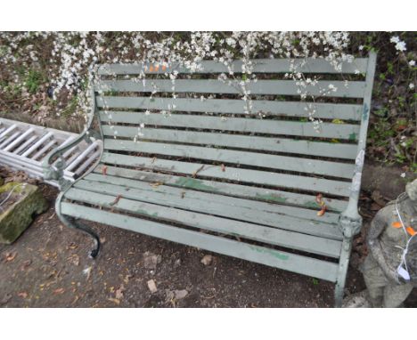 A LATE 20th CENTURY GARDEN BENCH, with cast iron ends, lion mask motifs and wooden slatted seat and back, width 125cm