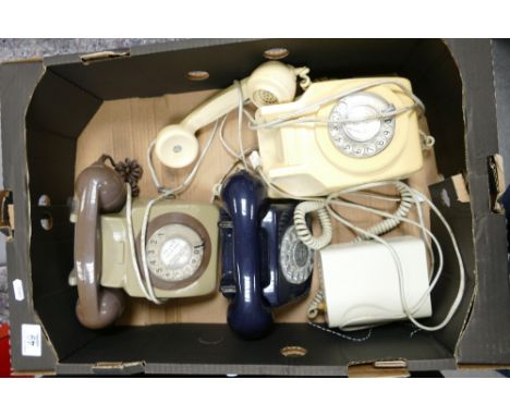 A collectionof mide century dial telephones: including 1977 commemorative item