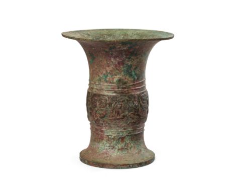 A Chinese archaic bronze ritual wine vessel, zunShang dynastyWith flared foot and rim, the mid-section decorated with typical