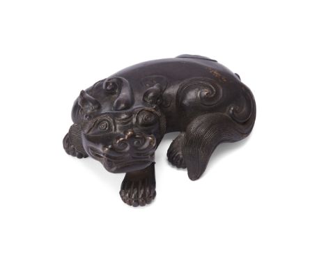 A Chinese bronze 'bixie' scroll weightQing dynasty, 18th/19th centuryThe recumbent beast well modelled, with a single curved 