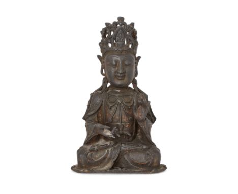 A Chinese bronze figure of GuanyinMing dynastyThe Bodhisattva seated in Padmasana with hands in Dharmachakra mudrā, wearing t